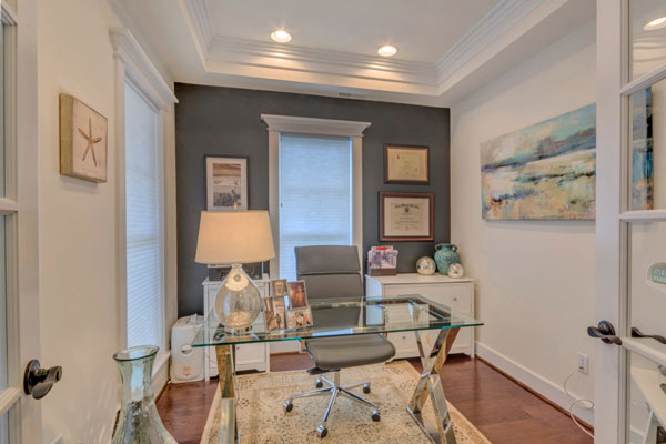 Home office with glass desk in The Villager Courtyard.