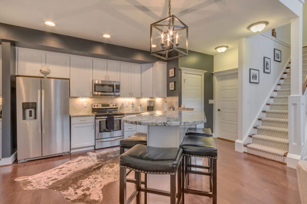 Kitchen in The Villager Courtyard featuring an island with leather stools.